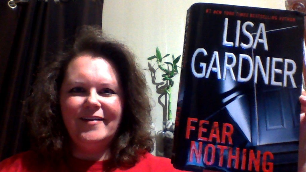 Me holding Lisa Gardner's book, Fear Nothing